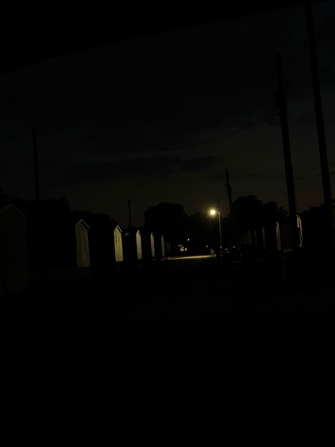 Dark residential lane with limited street lighting